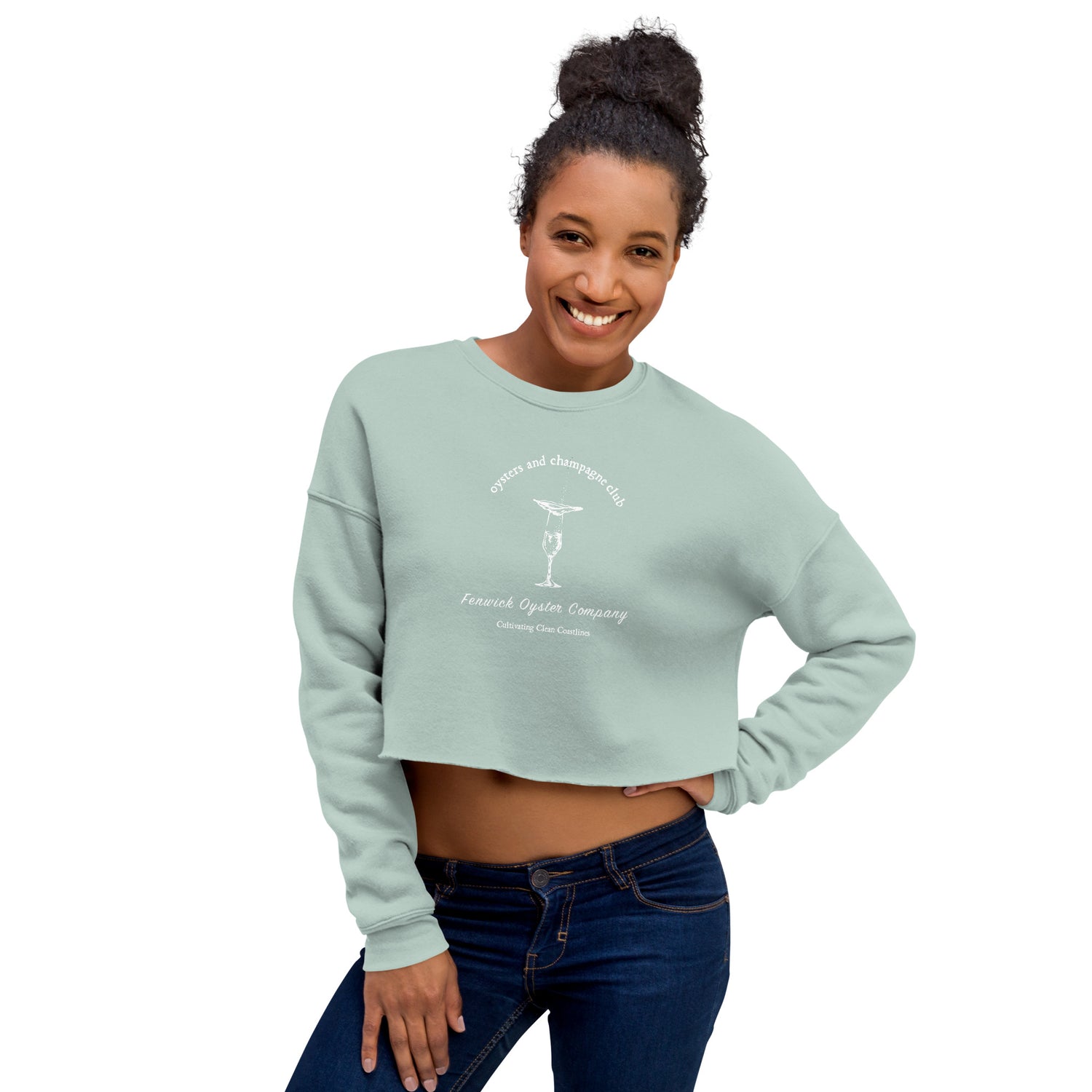 a dusty squa crop sweatshirt that reads "oysters and champagne club" with an image of a filled champagne glass and an oyster on the half shell resting on top. champagne and oysters